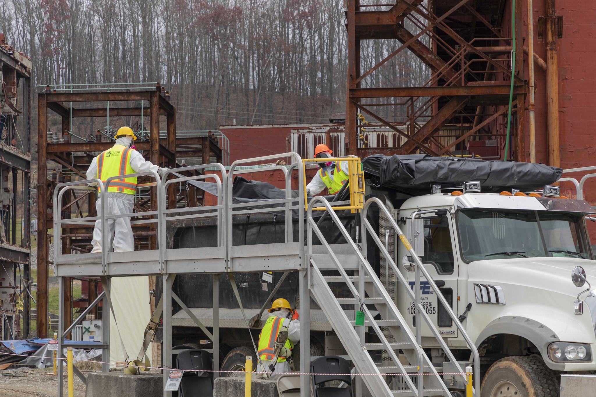 Photo: workers prep trucks to haul debris