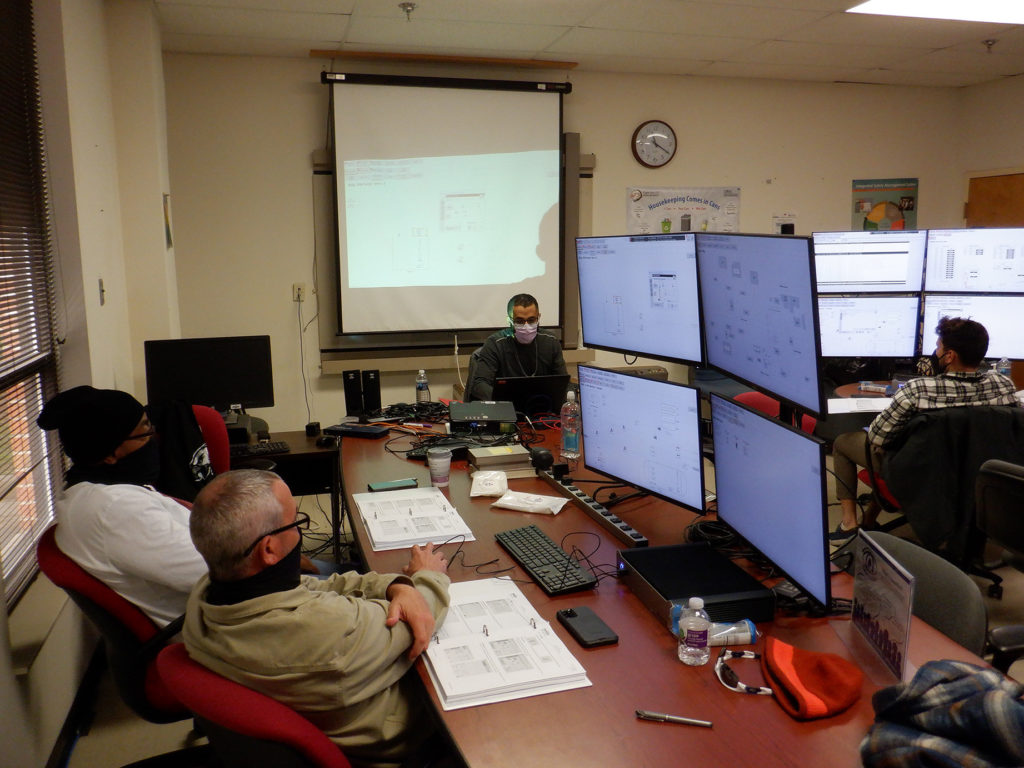 Photo of UCOR employees doing troubleshooting prior to installing the new Distributed Control System.