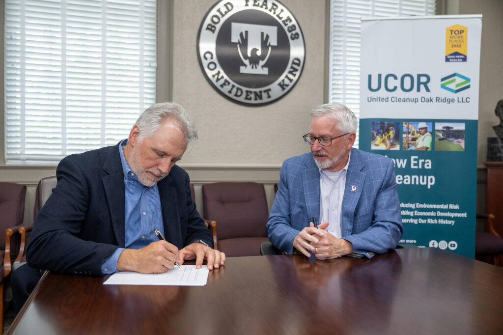 Photo: UCOR president Ken Reuter signs memorandum of understanding with Tennessee Tech University. Also pictured is TTU president Phil Oldham.