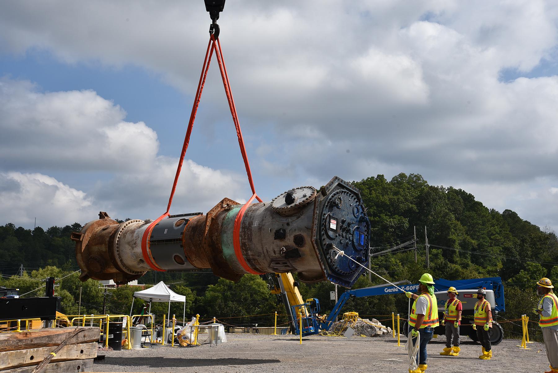 Photo of workers preparing to load the ORNL Low Intensity Test Reactor into a custom container for disposal