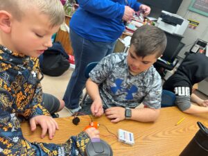 Photo of two elementary school students exploring "squishy circuits"