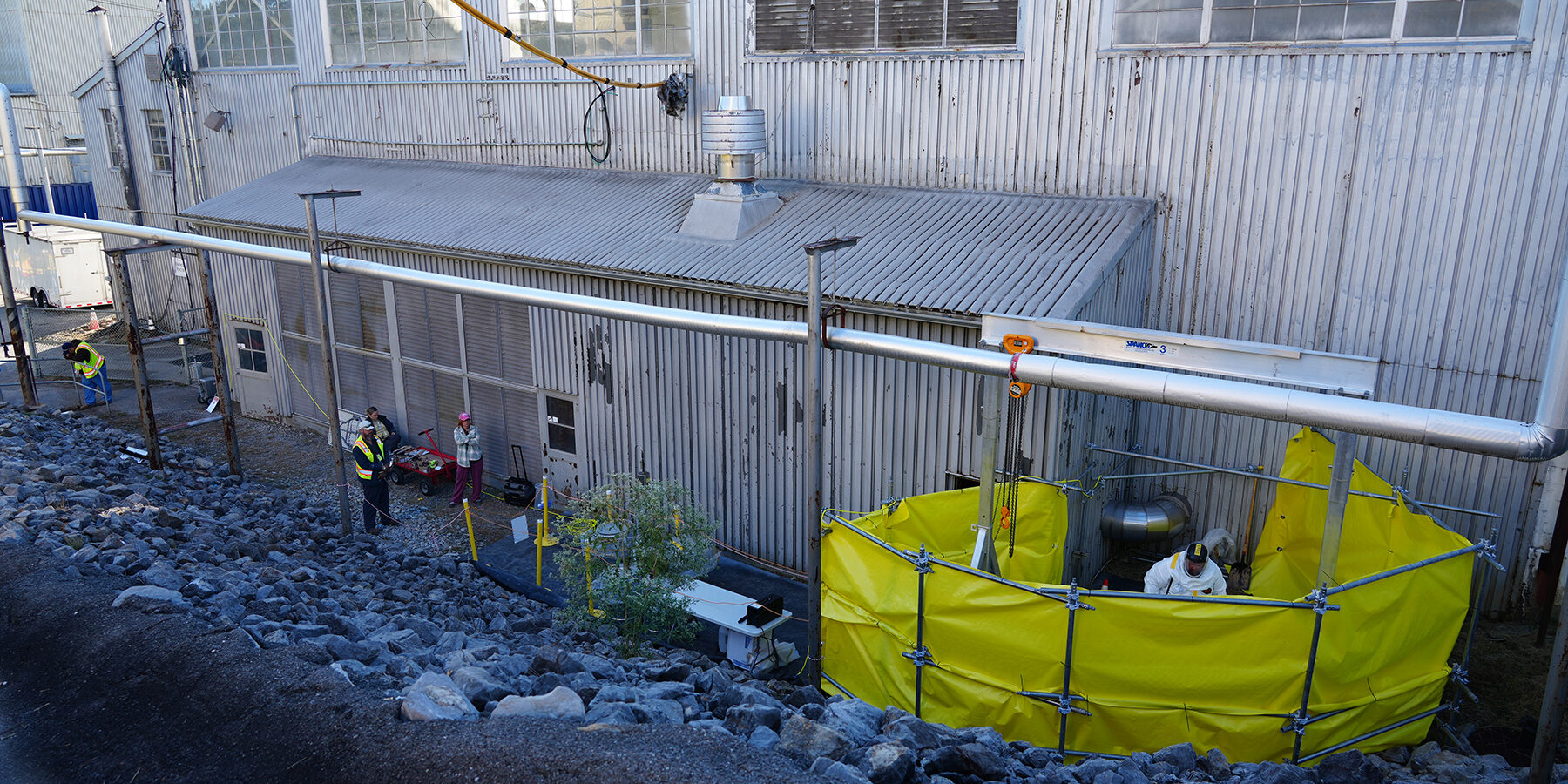 3002_duct_cap Workers removing a duct cap outside of ORNL Graphic Reactor Building