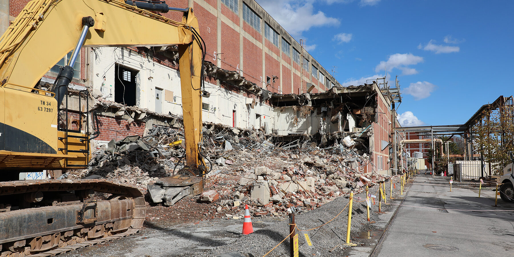 Alpha 2 demo progress Excavator doing demolition on the main Alpha-2 building