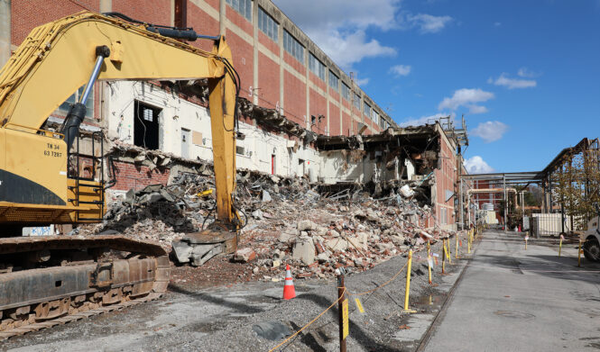 Alpha 2 demo progress Excavator doing demolition on the main Alpha-2 building