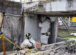 Two workers conducting electrical isolations at ORNL building 3518