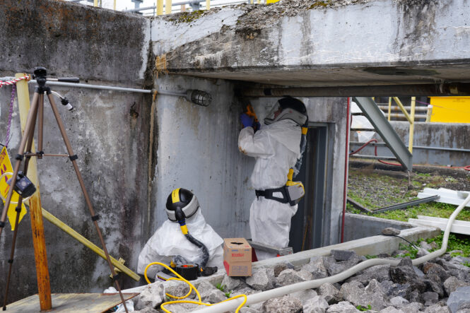 3518_Isolations Two workers conducting electrical isolations at ORNL building 3518