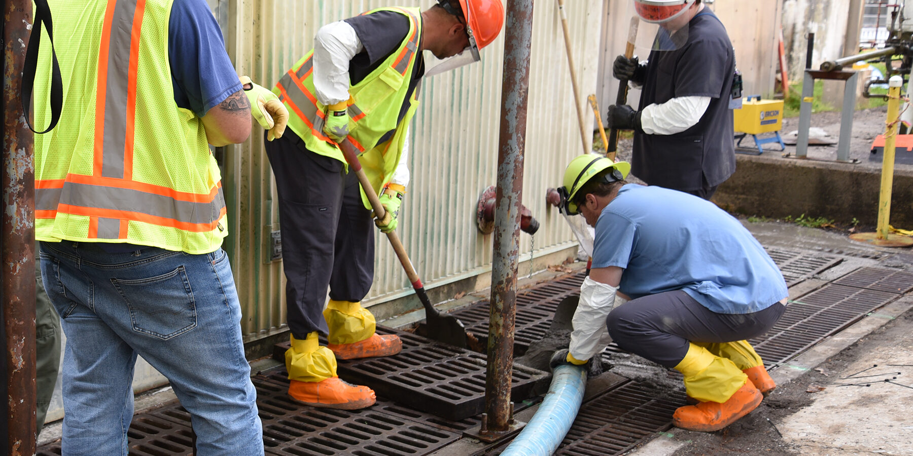 ORNL Workers filling utility trench