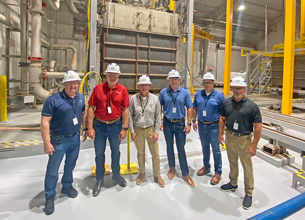 UCOR_tour_group_sodium_shields Group photo of OREM and UCOR officials visiting the Waste Control Specialists facility in Andrews, Texas, to observe a demonstration project that has created a disposal path for reactive metals.
