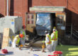 Four UCOR workers removing glove box from ORNL building 3038