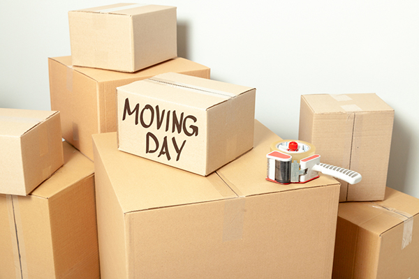 Day,Moving.,Cardboard,Boxes,On,Gray,Wall,Background.