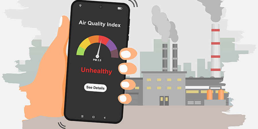 Hand,Holding,Smartphone,To,Check,Air,Quality,Index,With,Industrial
