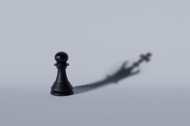 Black,Chess,Pawn,Casting,A,Shadow,Of,A,Crown,,Symbolizing