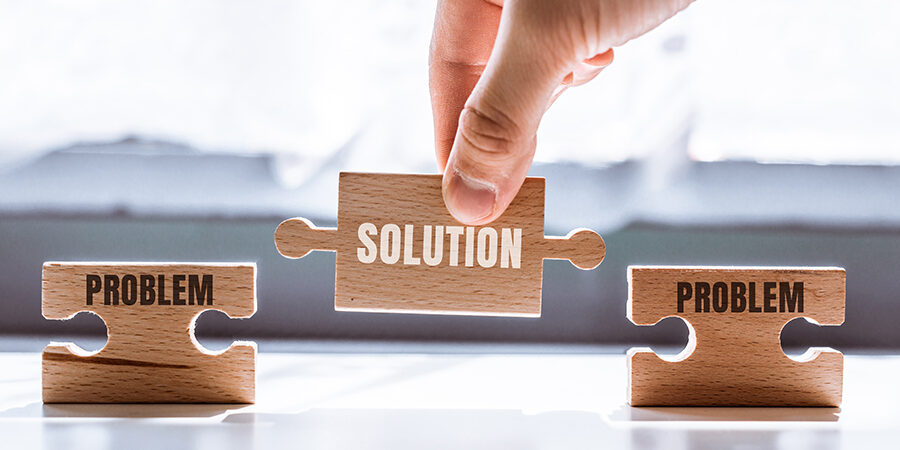 Hand,Holding,A,Wooden,Puzzle,With,The,Word,Solution.,There