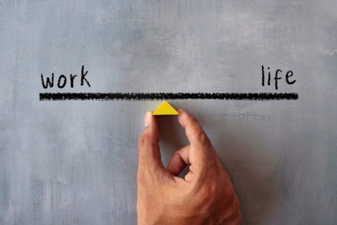 Top,View,Image,Of,Hand,Holding,Wooden,Triangle.,Work,Life