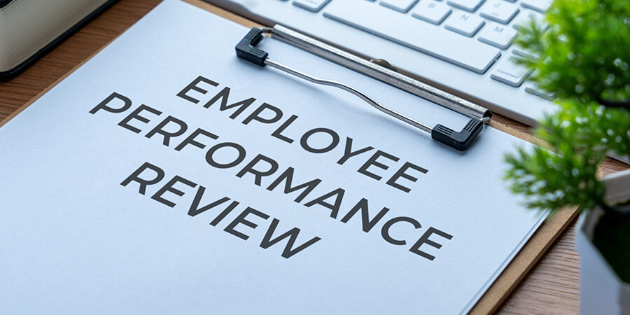 A,Clipboard,Holding,An,Employee,Performance,Review,Document,On,A
